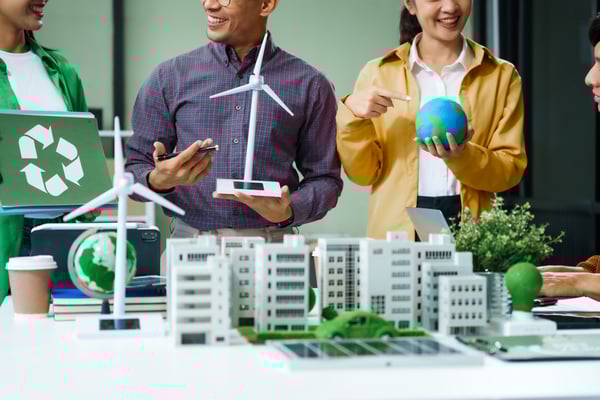 colleagues-meet-at-desk-brainstorm-environmental-m-2025-03-06-23-02-27-utc-1